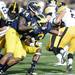 Michigan safety Marvin Robinson wraps up Iowa wide receiver Jordan Cotton in the third quarter at Michigan Stadium. Melanie Maxwell I AnnArbor.com